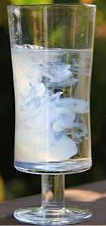 Photo of a glass with mingling water and another substance